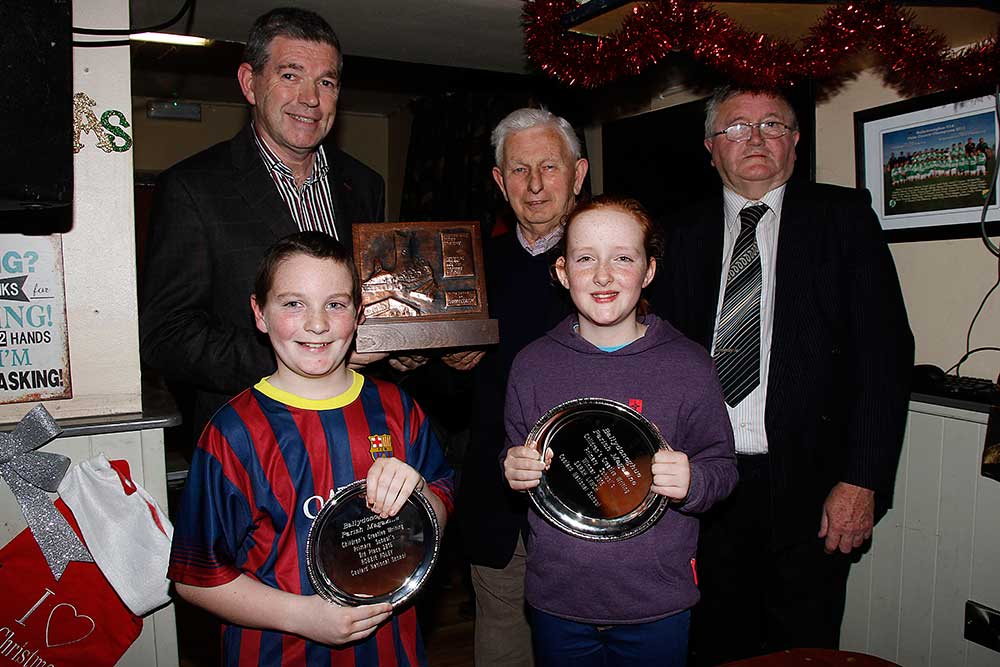 Sarah Lynch and Robbie Foley accepting their “Children’s Writing Competition” awards. Front: Robbie Foley, Sarah Lynch. Back: Maurice O’Mahony, Mick Browne, John Keane.